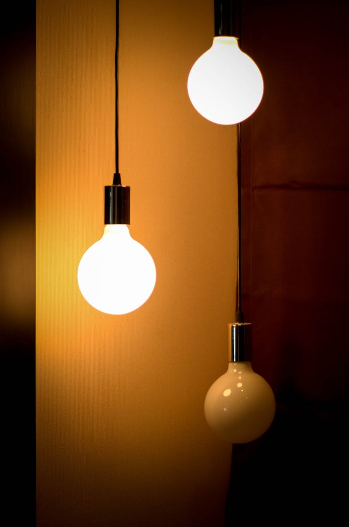 services-01 Composition of three glowing light bulbs creating a warm ambiance. Ideal for energy and design themes.